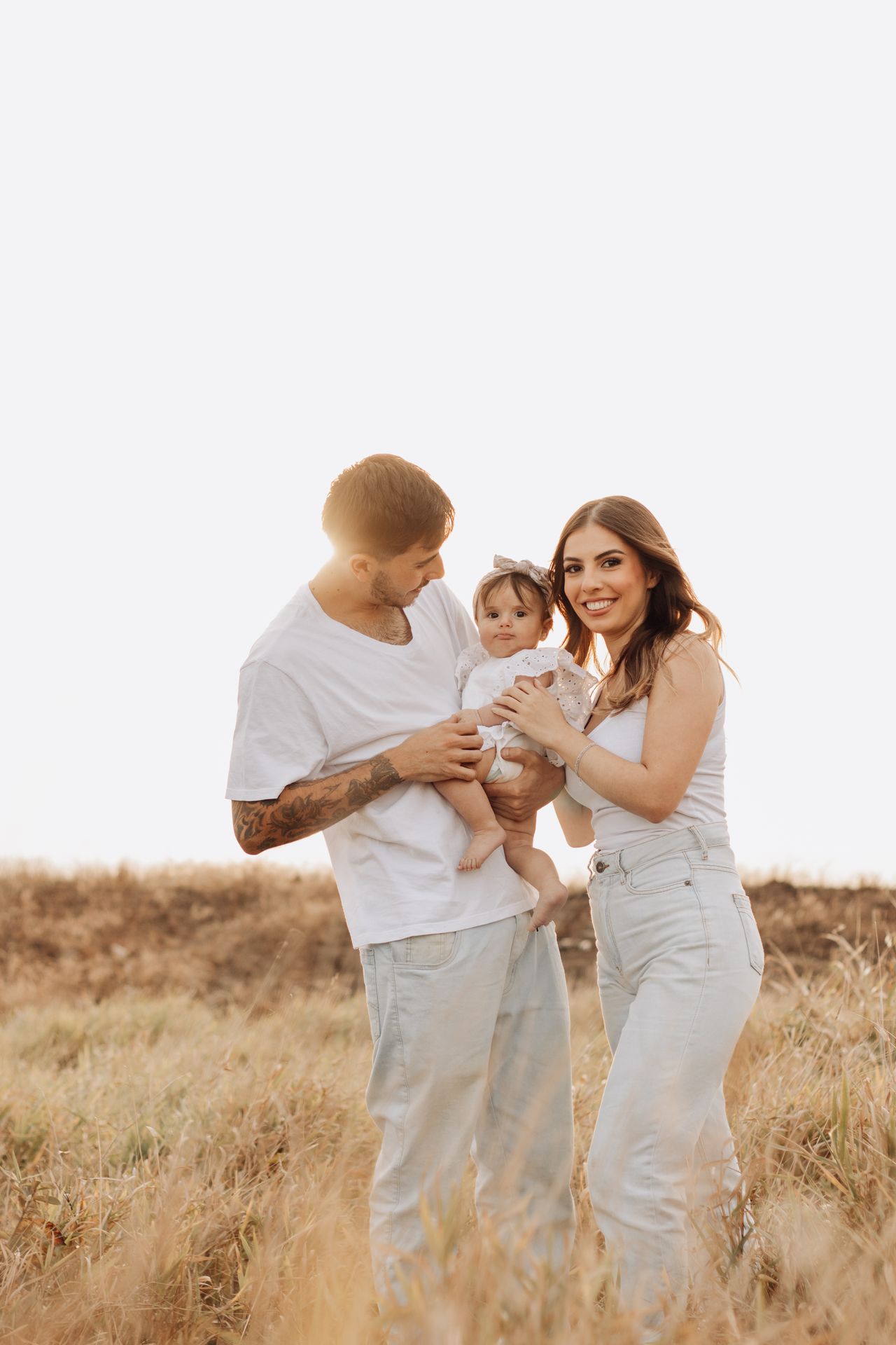 Family standing together at sunset